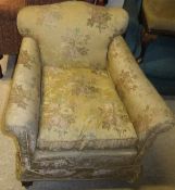 An early 20th Century upholstered scroll arm chair on cabriole legs to claw and ball feet