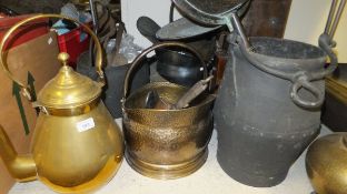 A collection of metalwares to include an Eastern style brass jug with swing handle,