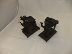 A pair of Chinese bronze stands as stylised lion and stylised cow,