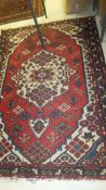 A Caucasian rug, the central medallions in cream, red,