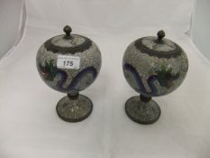 A pair of Chinese cloisonné spherical shaped jars and covers, raised on pedestal to circular foot,