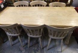 A modern limed oak refectory style dining table on turned and ringed supports united by a centre