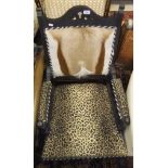 An Edwardian ebonised framed salon chair with later upholstery, the back in Impala hide,