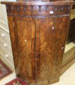 A 19th Century mahogany and inlaid bow fronted corner cupboard,