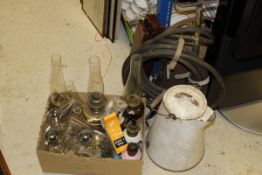 A box containing assorted oil lamps, chimneys, etc,