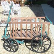 A mahogany framed four iron wheeled cart