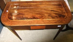 A 19th Century mahogany fold-over card table on square tapered legs to spade feet