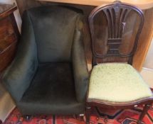 A Victorian green upholstered armchair raised on square tapering legs to castors,