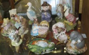 A collection of twelve Beatrix Potter figures including "Hunca Munca" (Royal Albert 1989),