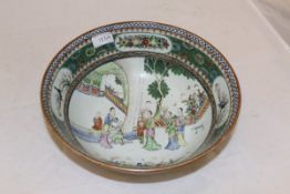 A 20th Century Chinese Kangxi style famille vert bowl with figural decoration to the centre field