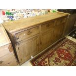 A Victorian pine dresser, the plain top with applied moulded edge above three drawers and three