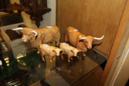 A Beswick figure of a Highland bull and another of a Highland cow,