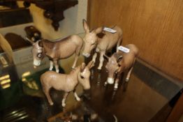 A selection of four Beswick donkey and foal figures CONDITION REPORTS All have some light wear and