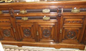 A Victorian walnut sideboard of one long and two short drawers above cupboard doors,