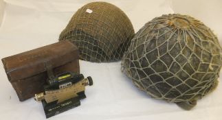 Three various World War II tin helmets, a Vickers Clinometer. .303 IN.MG.MKII, 1943, No'd 3392, in