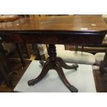 A Victorian mahogany fold-over card table on pedestal quartered base and scroll feet