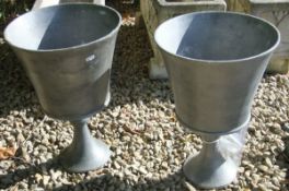 Two aluminium pots on stands