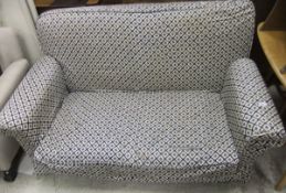 An early 20th Century upholstered drop arm sofa