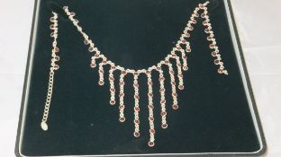 A silver and garnet set necklace
