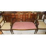 An Edwardian mahogany and inlaid two seat salon settee and a pair of similar salon open arm chairs