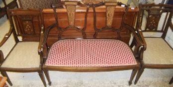An Edwardian mahogany and inlaid two seat salon settee and a pair of similar salon open arm chairs