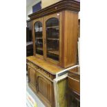 A Victorian walnut bookcase cabinet with two glazed doors over two drawers and two cupboard doors