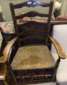 A 19th Century elm rush seat ladder back elbow chair