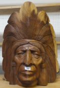 A carved wooden mask/ornament depicting a Native American Chieftain with feathered head dress