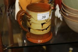 A 19th Century slipware decorated glazed mug,