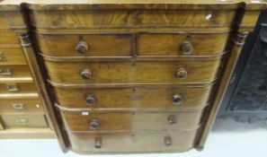 A mahogany chest of two short and four long drawers with turned column decoration to sides