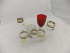 A large collection of drinking glasses with gilt decorated rims to include brandy balloons, wines,