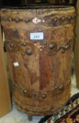 A leather covered wooden and stud mounted umbrella stand (probably formerly a cordite carrier)