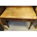 An Edwardian mahogany two drawer desk on turned legs to white china castors,