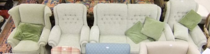 A modern four piece lounge suite comprising two seat sofa, two single armchairs and pouffe,