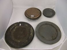 A collection of 18th Century and later pewter plates, bearing various touch marks,