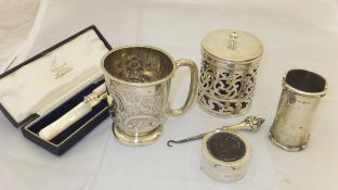 A Victorian silver small mug with embossed floral decoration,