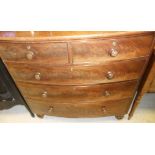 An early Victorian bow fronted chest of two short and three long graduated drawers on turned feet