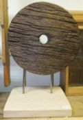 A wooden maize wheel mounted as a sculpture on a wooden plinth base CONDITION REPORTS Some newer