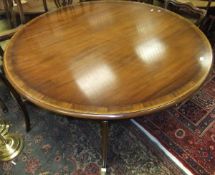 A reproduction mahogany circular dining table