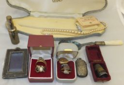 A box containing various 9 carat gold and other rings, a gold coloured heart shaped locket,