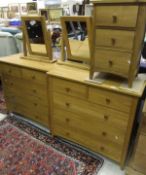 A pair of modern oak chests of two short over three long drawers,