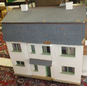 A late 20th Century painted wooden dolls house by Tristram Pinecoffin, with various furniture,