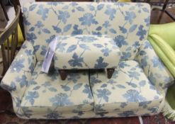 A Mulityork blue floral upholstered two seater sofa and matching rectangular footstool