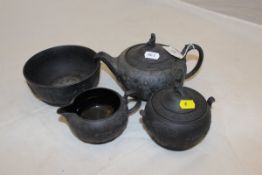 A 20th Century Wedgwood black basalt teapot and lidded sucrier with similar cream jug and slop