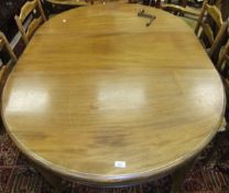 An Edwardian mahogany oval extending dining table on square chamfered legs,