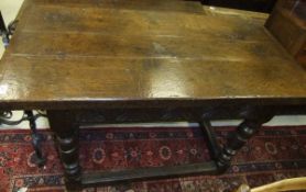 A 17th Century oak refectory style serving table, the three plank top with cleated ends above a