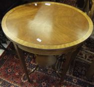 An oval mahogany occasional table with inlaid decoration on square tapering legs united by an