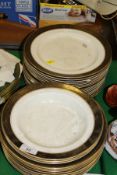 A collection of Booth's silicon china gilt decorated dinner plates and bowls and a toilet mirror