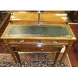 An Edwardian satin walnut bureau de dame with two rising compartments above a tooled and gilded