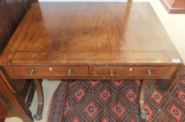 A 19th Century mahogany sofa table, the drop leaf top with rosewood banded decoration, over two